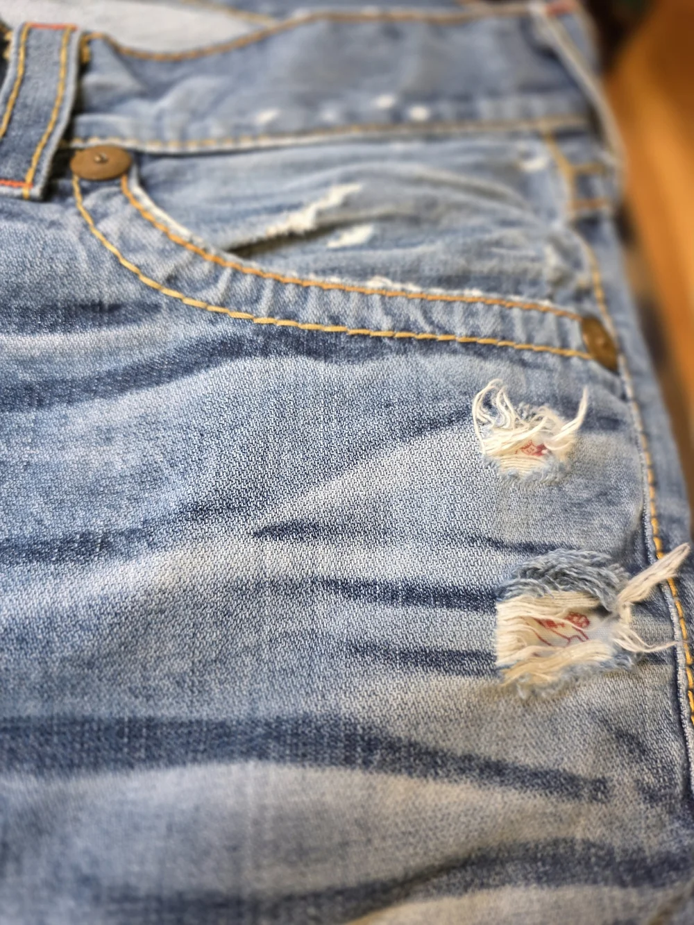 TRUE RELIGION Light Wash Cutoff Denim Shorts with Embroidered Back Pockets